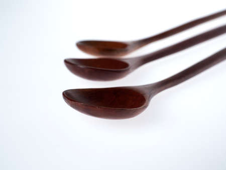 wooden spoons on a white backgroundの写真素材
