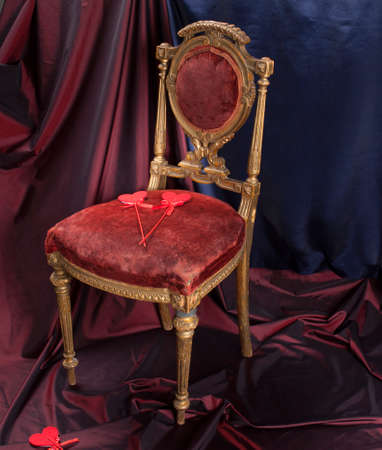 a large red heart and small hearts with an antique chair. Valentine's Day