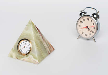 clock in the shape of an alarm clock and a pyramidの写真素材