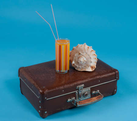 lemonade in a glass with an old suitcase and a sink, a composition about the sea rest.の写真素材