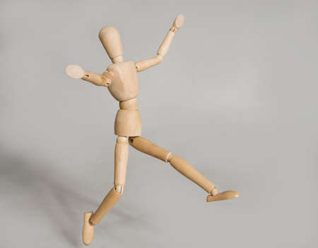 puppet in motion on grey background.の写真素材