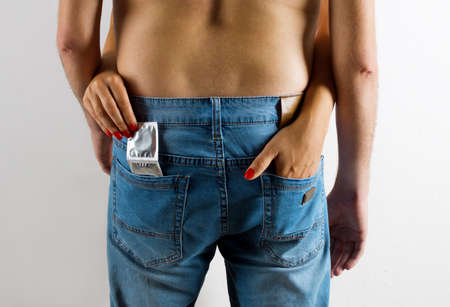woman gets out of the pocket men's jeans condom.の写真素材