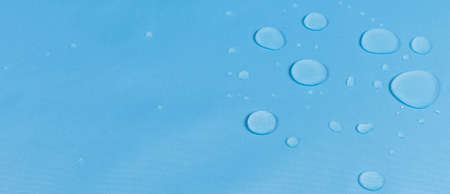 drops of water on the surface of the fabric. macro. sky blue colorの写真素材