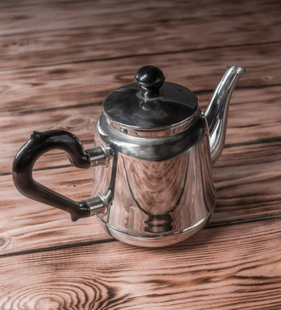 old metal coffee pot on a wooden background. object shooting.の写真素材