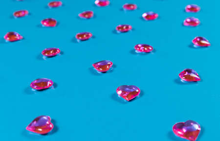 Valentines Day concept. Glass transparent hearts on a blue background, glass heart glows, painting on glass. Love for Valentines Day. The trendy color is classic blue. Copy spaceの写真素材