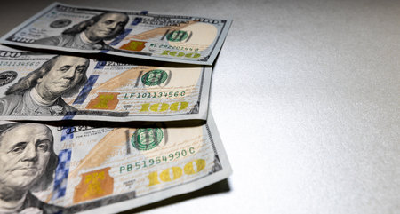 dollar bills fanned out on a light background.