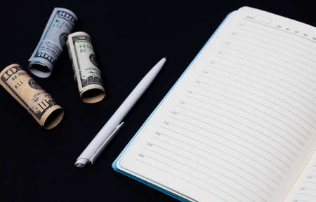 White pen and American banknotes, blank sheet and white pen, dollars and notepadの写真素材