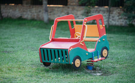 Wooden baby car on two springs on kids playground.の写真素材