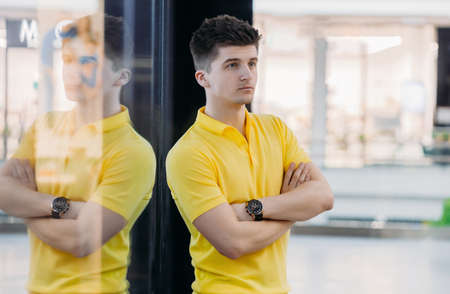 Portrait of a smart, executive man, arms crossed, ready to make decisions in stylish clothes on a...