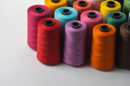 Multicolored spools of thread isolated on white.