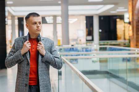 Handsome young boy in stylish light coat.