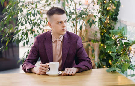 Young manager drinking coffee in the office during a break.の写真素材