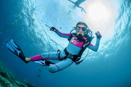 Child scuba diver underwater in the oceanの写真素材