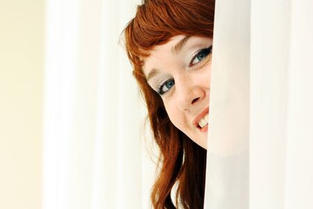 Portrait of a beautiful redheaded woman looking flirtatious.の写真素材