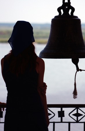 Silhouettes of girls and bells and the sea, the Orthodox Church.の写真素材