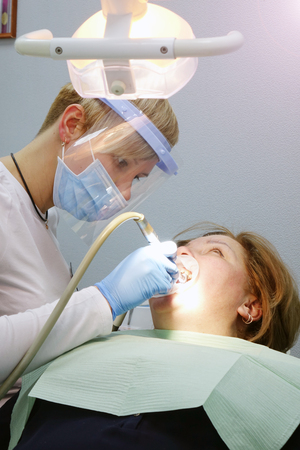 Dentist at work in the office. Treatment teeth.の写真素材