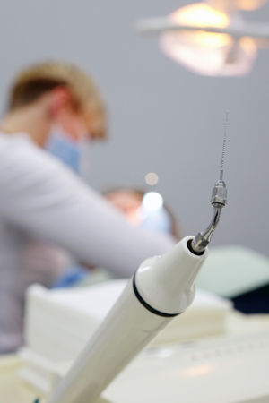 Hand tool, choosing a dentist for dental treatment of his patient. The dentist's office.の写真素材