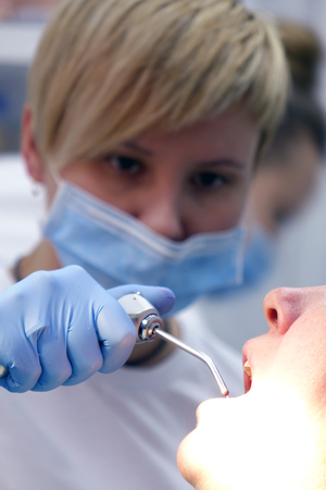 Dentist at work in the office. Treatment teeth.の写真素材