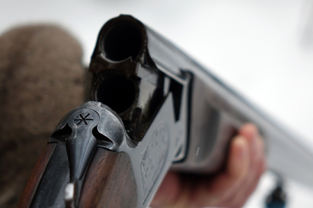 Hunter with gun and hunting ammunition. Hunting season.