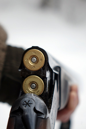 Hunter with gun and hunting ammunition. Hunting season.の写真素材