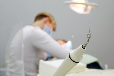 Hand tool, choosing a dentist for dental treatment of his patient. The dentist's office.の写真素材