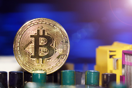 Cryptocurrency bitcoin gold. Bitcoins on the motherboard.