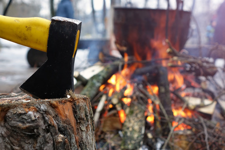 Tourist axe and a kettle over the fire.Cooking over fire in the woodsの写真素材