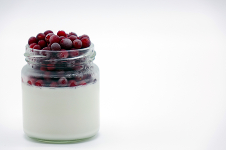 Fresh berries in the jar with the yogurt. On white background. Fruit yogurt.の写真素材
