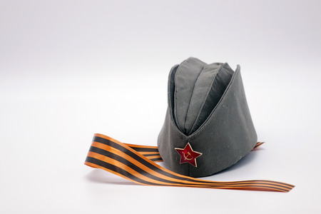 Military cap with Communist decoration, the Red star with hammer and sickle.St. George ribbon as a symbol of Victory.の写真素材