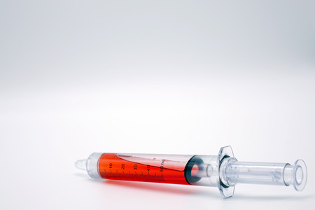 Syringe with blood isolated on white.Vaccination.の写真素材