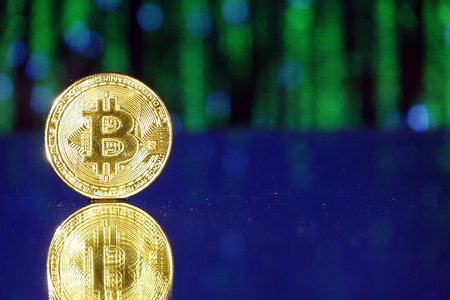 Cryptocurrency bitcoin gold. Bitcoin on a blue background .Virtual business.の写真素材