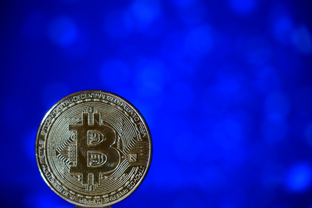 Cryptocurrency bitcoin gold. Bitcoin on a blue background .Virtual business.の写真素材