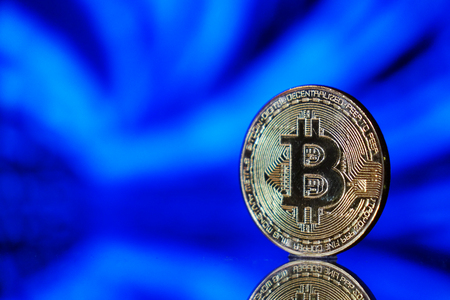 Cryptocurrency bitcoin gold. Bitcoin on a blue background .Virtual business.の写真素材