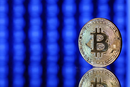 Cryptocurrency bitcoin gold. Bitcoin on a blue background .Virtual business.の写真素材