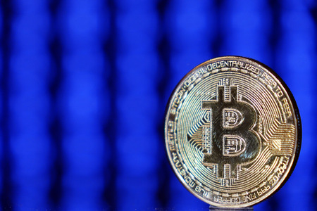 Cryptocurrency bitcoin gold. Bitcoin on a blue background .Virtual business.の写真素材