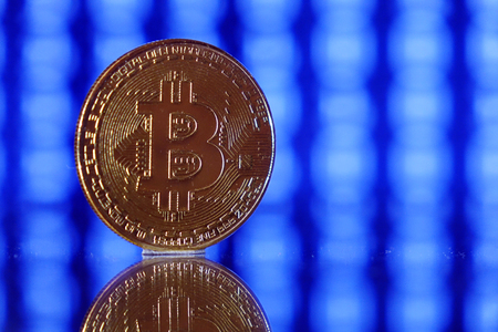 Cryptocurrency bitcoin gold. Bitcoin on a blue background .Virtual business.の写真素材