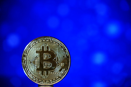 Cryptocurrency bitcoin gold. Bitcoin on a blue background .Virtual business.の写真素材