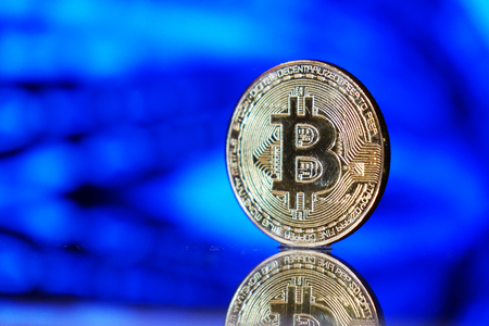 Cryptocurrency bitcoin gold. Bitcoin on a blue background .Virtual business.の写真素材