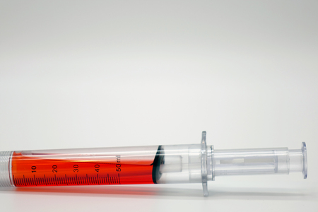 Syringe with blood isolated on white.Vaccination.の写真素材