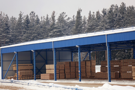 Lumber warehouse.New Stacked pallets .Forest industryの写真素材