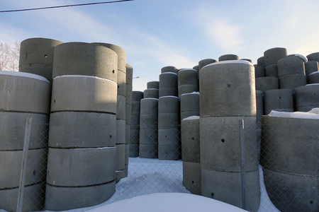 Lie in the street of the concrete ring. Construction material of gray color for wells.の写真素材