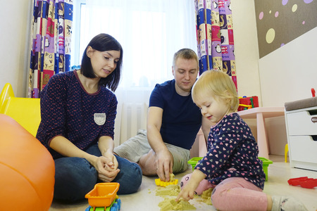 A young family plays at home with a childの写真素材