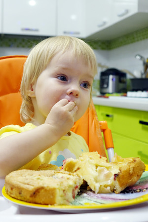 Little girl eating cake.の写真素材