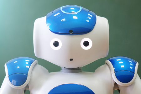 A small robot with a human face and a humanoid body. Artificial intelligence - AI. Blue-and-white robot.の写真素材