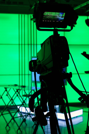 Silhouette of digital video camera in front of the green screenの写真素材