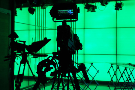 Silhouette of digital video camera in front of the green screenの写真素材