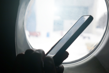 Smartphone at the window. Business technology and the concept of travel ideas.businessman
