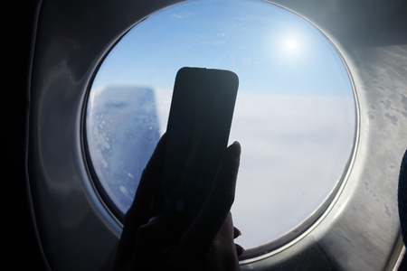 Smartphone at the window. Business technology and the concept of travel ideas.businessmanの写真素材