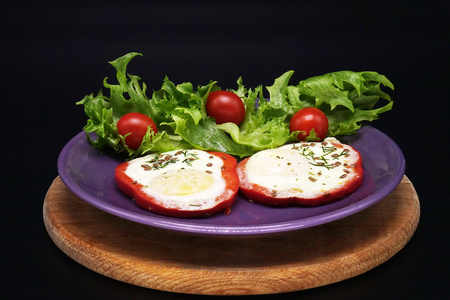 Scrambled eggs in red pepper and saladの写真素材
