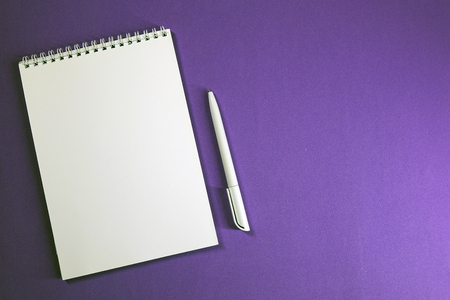Notepad and pen on colored background top view, school, business, education, knowledgeの写真素材
